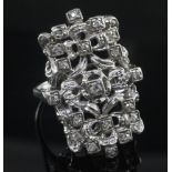 An 18ct white gold and diamond set modernist dress ring, of free form rectangular design, size V.