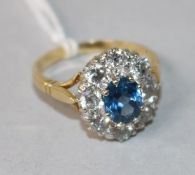 A 1970's 18ct gold, sapphire and diamond oval cluster ring, size P.