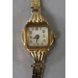 A lady's 9ct gold manual wind wrist watch on a 9ct gold bracelet.