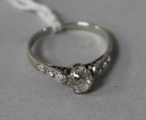 An 18ct white gold and platinum, single stone diamond ring, with diamond set shoulders, size L.