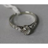 An 18ct white gold and platinum, single stone diamond ring, with diamond set shoulders, size L.