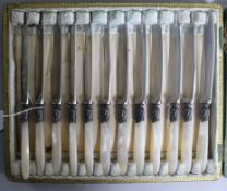 Two cased sets of twelve mother of pearl handled knives and a cased carving set.
