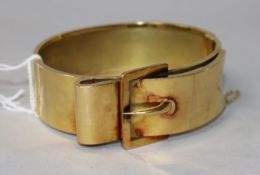 An early 20th century yellow metal "buckle" design hinged bangle.