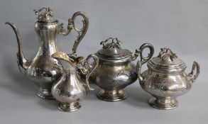 A late 19th/early 20th century French four piece engine turned silver tea and coffee service by