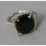 A Tiffany & Co silver, black stone and diamond dress ring, size J.