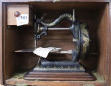 A Victorian Newton Wilson & Co sewing machine, with contemporary manual