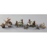 A collection of Austrian cold painted bronze miniatures, comprising dogs drinking at tables (2), a