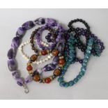 Three assorted necklace including amethyst and five assorted bracelets.