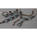 An early 20th century yellow and white metal, blue zircon and white stone parure and a similar