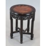 An early 20th century Chinese hardwood occasional table, with burr wood inset top and lotus carved