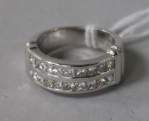 A modern 18ct white gold and twin row channel set diamond ring, size M.