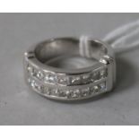 A modern 18ct white gold and twin row channel set diamond ring, size M.