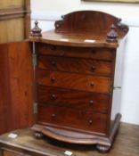 A mid Victorian mahogany bowfronted cupboard, fitted six small drawers, enclosed by a door W.41cm