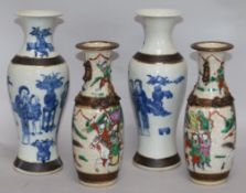 An early 20th century pair of crackle glazed vases and a pair of blue and white vases H.29cms
