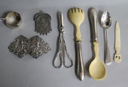 A small group of silver and white metal items including salad servers, buckle, purse and plated