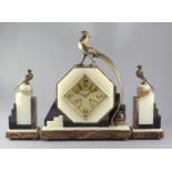 A 1930's onyx and hard stone mantel clock garniture, the octagonal case surmounted by a stylised