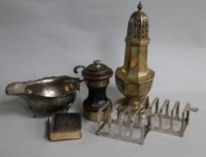 A pair of silver toast racks, a silver sauceboat and silver sugar caster etc.