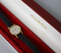 A lady's 18ct gold Omega manual wind wrist watch, with Omega box