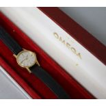 A lady's 18ct gold Omega manual wind wrist watch, with Omega box