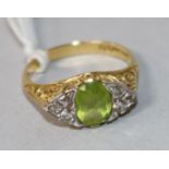 An 18ct gold, peridot and diamond cluster ring, size N.