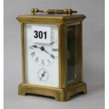 A brass carriage alarm clock 12cm.