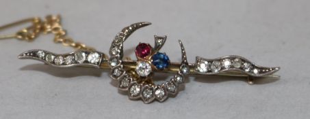 An early 20th century yellow metal, diamond and gem set crescent bar brooch, 49mm.