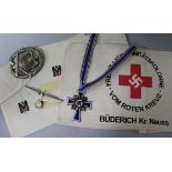 A German Red Cross arm band and paperwork, a mothers cross, a general assault badge