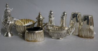 A small silver fluted cream jug and various silver condiments, including a William Hutton & Sons