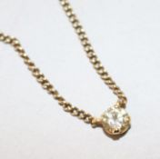 A yellow metal and solitaire diamond pendant necklace, 40cm.