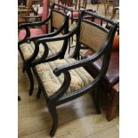 A pair of Regency style ebonised ropetwist back elbow chairs