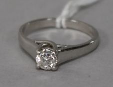 A modern 18ct white gold and solitaire diamond ring, size M.