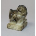 A Chinese jade figure of a Buddhist lion and a slate inkstone 4cm & 13cm.
