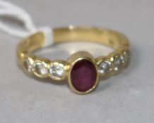 An 18ct gold, ruby and diamond half hoop ring, size O.