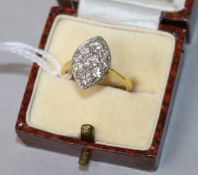 A modern 18ct gold and nine stone diamond set marquise ring, size L.