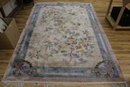 A Chinese fawn ground carpet, 274 x 184cm