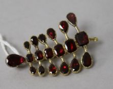 A yellow metal and foil backed garnet brooch, 48mm.