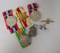 Four WW2 medals, three to the name on the box B.A. Ingram, a silver ARP badge, a silver RAF brooch