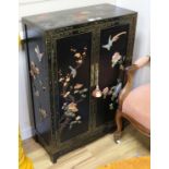 A Chinese black lacquered two door cupboard, inset hardstones, W.67cm