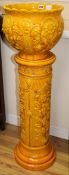 A Burmantofts "faience" amber glazed pottery jardiniere and pedestal, overall height 105cm