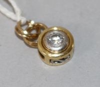 A modern 18ct gold and diamond set pendant, overall 17mm.