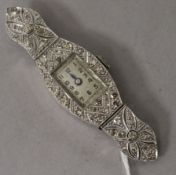 A lady's mid 20th century platinum and diamond set cocktail watch, with diamond set case and lugs (