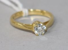 A modern 18ct gold and solitaire diamond ring, size I.