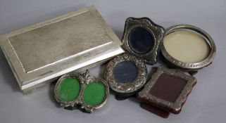 A white metal mounted cigarette box and five small photograph frames including four silver.
