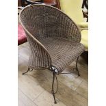 A wicker and iron tub chair