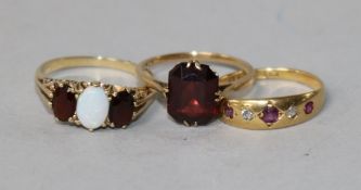 A 9ct gold, opal and garnet ring, scrolled carved mount, an 18ct gold, ruby and diamond gypsy-set