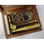 Two early 19th Century brass travelling microscopes, Rand of Newbury and another, with early