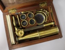 Two early 19th Century brass travelling microscopes, Rand of Newbury and another, with early
