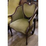 A late Victorian inlaid mahogany armchair, with shaped back