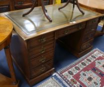 A late Victorian mahogany pedestal desk, fitted nine small drawers, with a green leather inset
