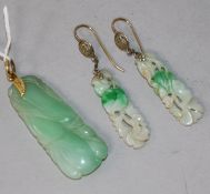 A carved jade pendant and pair of carved jade earrings.